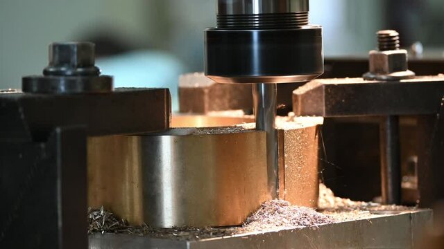 4K footage NC milling machine plunge cutting  brass material part by solid flat endmill tools. The shop floor operation by NC milling machine.