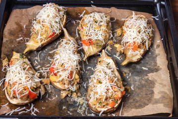 Eggplant stuffed on them, prepared for baking on a baking sheet, top view