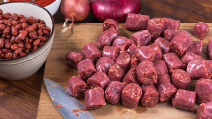 Ingredients for a Texas country, cowboy dish - Beans with beef sausages - canned beans, onions, chopped raw beef sausages, tomato paste