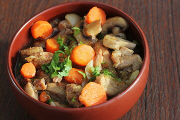 Meat stew with vegetable on rustic wooden background