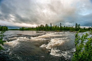 Stormy rapids river against a stormy sky