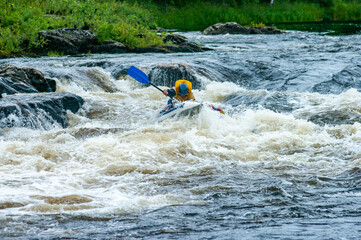 Guys in catamaran overcomes threshold of mountain river, boiling water. Rafting concept.