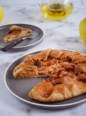 Quince galette with fresh quince. Traditional rustic fruit homemade pie, top view.