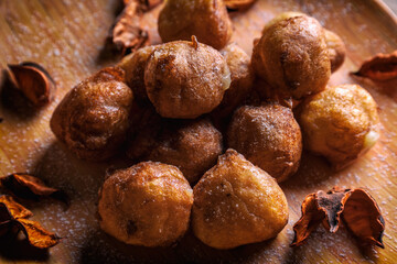 Bunuelos de viento - traditional Colombian sweet deep fried pastry. Spanish Easter doughnut. Mexican golden, crispy-sweet, tortilla-like fritters are sprinkled with sugar
