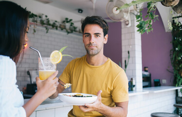 Content young couple having lunch in cafe