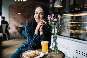 Content woman sitting in cafe