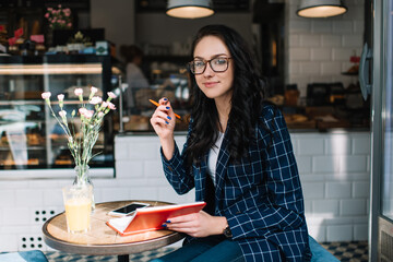 Young woman with notebook in cafe