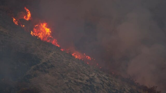 Large flames from fire burning on the mountainside in Utah in Springville.