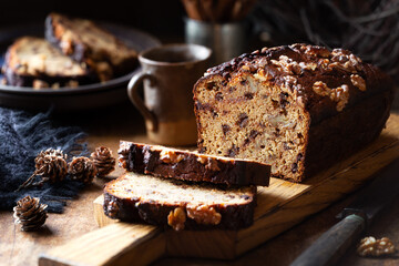 Delicious homemade chocolate and walnut gluten free banana bread sliced on wooden bread
