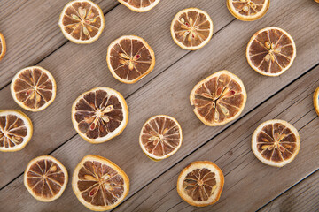 Looking down on the background of dried lemons evenly laid out on a wooden board