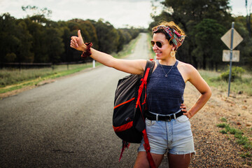 Solo female traveller hitchhiking on the road
