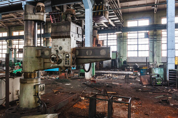 An abandoned old large industrial hall is waiting for demolition, an Industrial machine for metal processing, A former Khabarovsk plant for the production of a diesel engine.