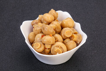 Pickled champignons in the bowl