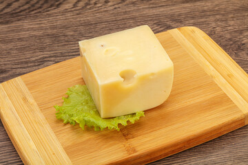 Emmental cheese over wooden board