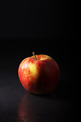 An apple against black background