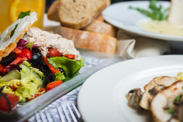 Top view of a restaurant table served with a multi-course set lunch and drink. Complex lunch.