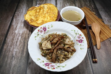 Spicy fried rice topping with grilled pork and chicken meat on the plate. Famous rice menu set in Asia restaurant. 