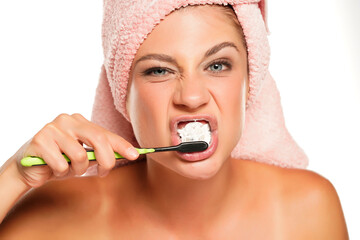 funny young woman brushing her teeth