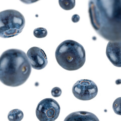 Many blueberries free falling on white background. Selective focus - shallow depth of field.