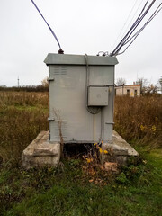 Transformer booth with wires and concrete pillars near it