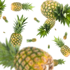 Fototapeta premium Many pineapples free falling on white background. Selective focus - shallow depth of field.