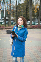 Fototapeta premium Young woman reading in tablet pc