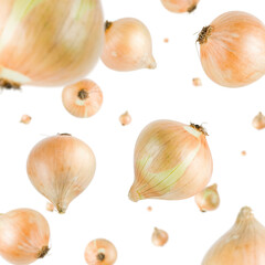 Many onions free falling on white background. Selective focus - shallow depth of field.