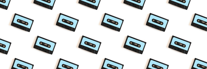 Cassette tapes pattern on a white background. Creative banner concept.
