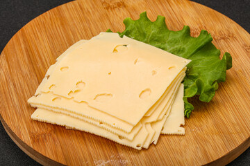 Sliced yellow cheese over board