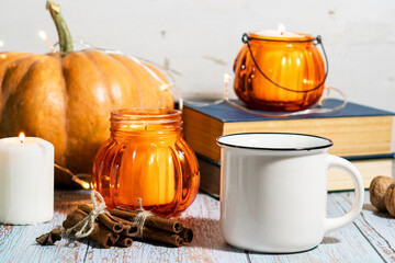Thanksgiving background, composition with pumpkins, dry autumn leaves, candles on wooden background. Autumn holiday, pumpkin harvest. Seasonal vegetables. 