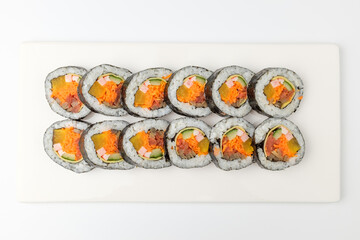 Gimbap with vegetables on white background