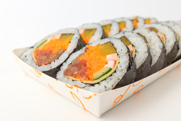 Gimbap with vegetables on white background