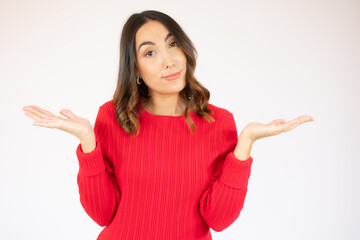 Young beautiful woman wearing casual red sweater over white isolated background clueless and confused, no idea concept.