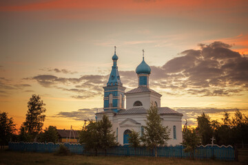 Fototapeta na wymiar orthodox old church in the village at sunset