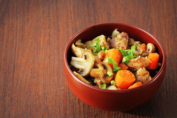 Meat stew with vegetable on rustic wooden background