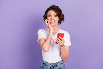 Photo portrait of crazy upset girl with bob hairstyle using smartphone biting fingers isolated on...