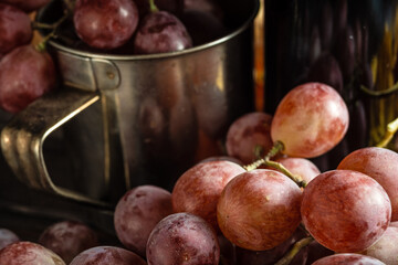 Autumn still life of red grapes on wooden background
