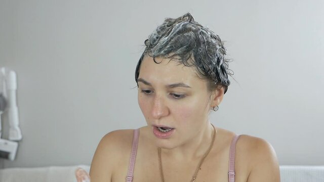 young woman suffers from hair loss during shower. Hair loss concept
