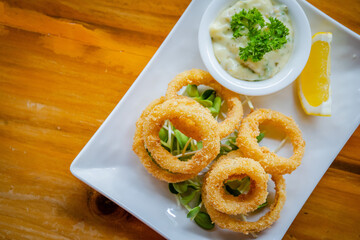 fried onion and lemon on table