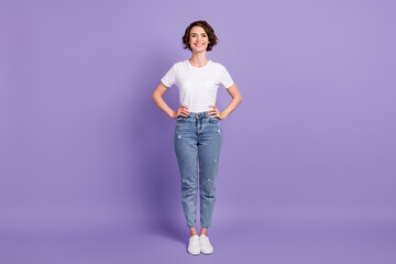 Photo portrait full length of woman standing with two hands on waist isolated on vivid purple...