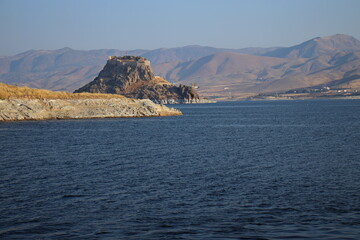A historical castle between the blue sky and the blue lake view, Pertek, Tunceli