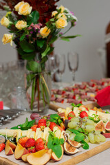 Catering. The buffet is decorated with bouquets and many delicious dishes.