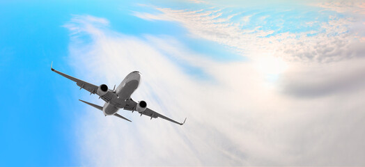 White passenger airplane over the clouds  - Travel by air transport