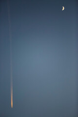 Sunset, moon and airplane in winter in Girona, Catalonia, Spain