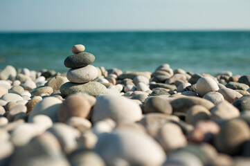 Feng Shui. Pyramid. Round stones on the beach.