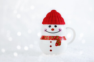 Christmas background. Happy snowman standing in winter christmas landscape. Merry christmas and happy new year greeting card. Mug funny snowman in a hat on a snowy background. Copy space