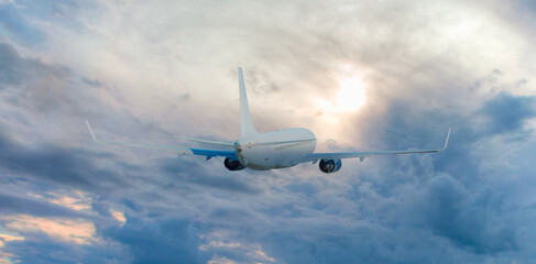 White passenger airplane over the clouds  - Travel by air transport