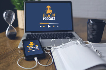 Podcast concept on laptop and smartphone screen over wooden table