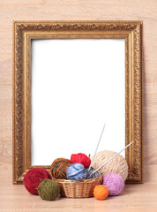 Multicolored balls of wool on a wooden table