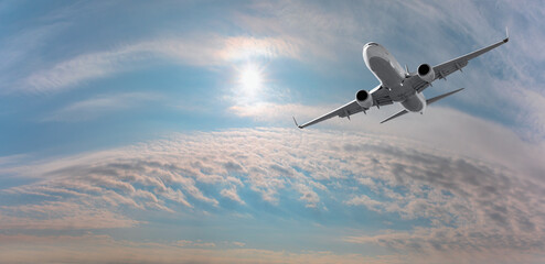 White passenger airplane over the clouds  - Travel by air transport